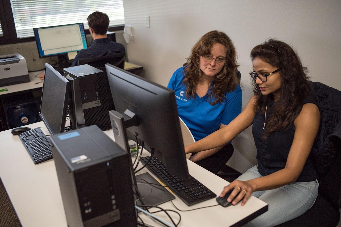 staff member helping student at the computer